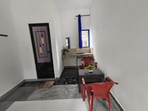 a room with a table and two chairs and a door at Johns Villa in Sultan Bathery +12 photos