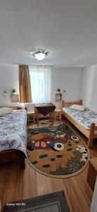 a room with two beds and a pool table at Pensiunea Rustica La Avram Lunca Ilvei in Lunca Ilvei