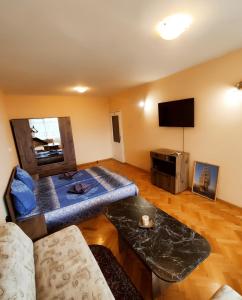 a living room with a couch and a table at Mercury Guest House in Veliko Tŭrnovo
