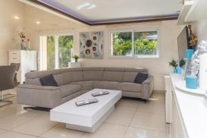 a living room with a couch and a table at Villa du Leman in Thonon-les-Bains