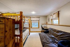 a room with two bunk beds and a couch at Sunday River Sunny Chalet in Bethel