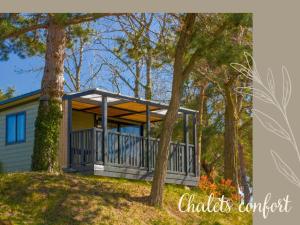 a home with a screened porch in the woods at Hotel De Plein Air Le Chanset in Ceyrat