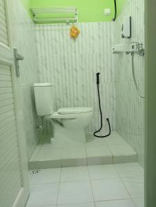 a bathroom with a toilet and a shower at Mentigen Homestay in Ngadisari