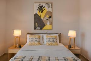 a bedroom with a bed with two lamps at Villa Siora Anna in Skala