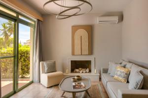 a living room with a couch and a fireplace at Villa Siora Anna in Skala