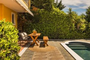 a patio with a table next to a pool at Villa Siora Anna in Skala
