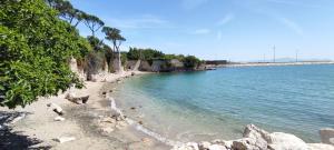 a beach with a group of people on the water at Casa OASI in Formia