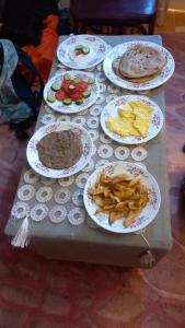 a table with plates of food on it at charming nubian guest house in Aswan