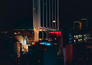 a lit up building in a city at night at SO City Hotel Adults Only in St. Julianʼs