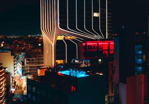 a view of a city at night at SO City Hotel Adults Only in St. Julianʼs