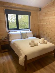 a bedroom with a large bed with a window at Rosies Cabin Maum in Galway