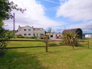 a wooden fence in front of a house at Pantysgyfarnog near Carmarthenshire Pembrokeshire in Carmarthen