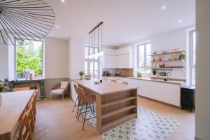 a kitchen with a table and chairs in a room at WeLiving in Caen