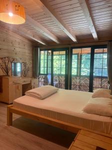 a large bed in a room with windows at Ayder Gencal Villa in Ayder Yaylasi