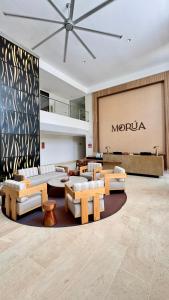 a lobby with couches and a maronia sign on a wall at Hotel Morúa in Yopal
