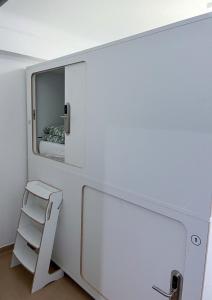 a small room with a ladder and a mirror at WOT Lisbon Nomad in Lisbon
