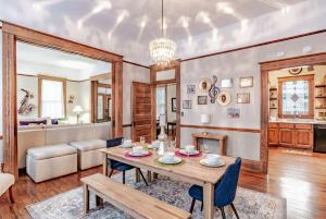 a living room with a table and a couch at Heavenly on Hunter-Historic Grandeur-The Cannon in Mobile