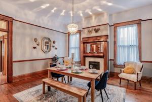 a dining room with a table and a fireplace at Heavenly on Hunter-Historic Grandeur-The Cannon in Mobile