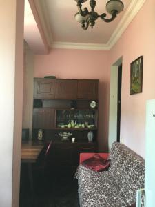 a living room with a couch and a table at Apartment Urushadze in Batumi +14 photos