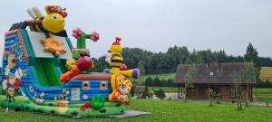 a large inflatable inflatable play structure in a field at Relax House in Varkaliai