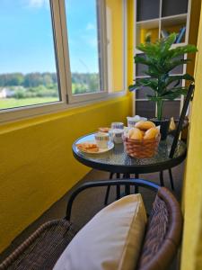 a table with food on it next to a window at JD apartment in Ozolnieki