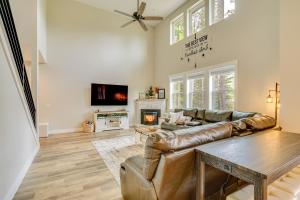 a living room with a leather couch and a fireplace at Spacious Donnelly Family Home with Private Hot Tub! in Donnelly