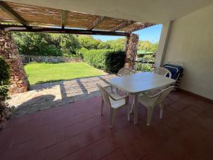 a table and chairs on a patio with a view of a yard at Villetta Marino P By La Via Del Mare Viaggi e Vacanze in San Stèfano +39 photos