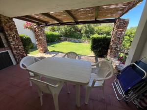 a white table and chairs on a patio at Villetta Marino P By La Via Del Mare Viaggi e Vacanze in San Stèfano