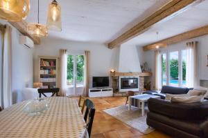 a living room with a table and a couch at La Saliniere in Roquefort-les-Pins