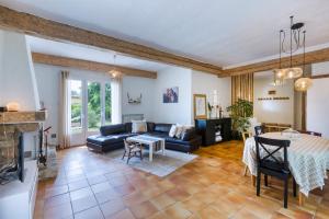a living room with a couch and a table at La Saliniere in Roquefort-les-Pins