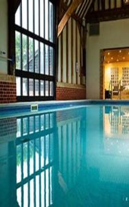 a large swimming pool in a building with a large window at Golf and Leisure Retreat in Great Yarmouth