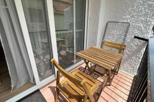 a wooden table and two chairs on a balcony at Apartment in the center of Fuengirola in Fuengirola