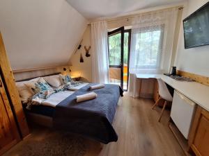 a bedroom with a bed with two towels on it at Pokoje Gościnne U Wandy in Zakopane +96 photos