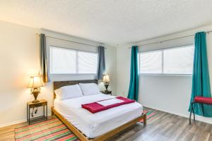 a bedroom with a large bed with blue curtains at Bullhead City Home - Near Colorado River! in Bullhead City