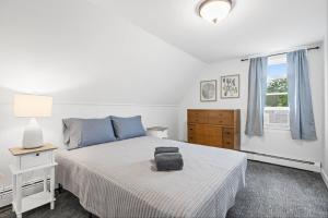 a bedroom with a bed with a suitcase on it at Downtown Plymouth Gem in Plymouth