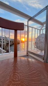 a bench on a boat with a view of the ocean at Bella Vista Grotta Ardito in Polignano a Mare