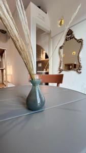 a blue vase sitting on a table with a mirror at Bella Vista Grotta Ardito in Polignano a Mare +23 photos