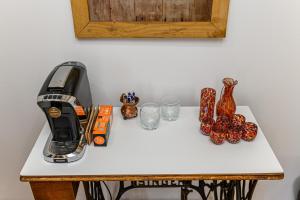 a table with a toaster and glasses on it at Penthouse Pensiunea Casa Bono in Braşov +21 photos
