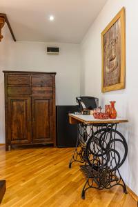 a room with a table and a cabinet at Penthouse Pensiunea Casa Bono in Braşov