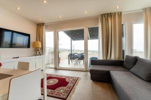 a living room with a couch and a tv and a table at Giovannino House in Catania