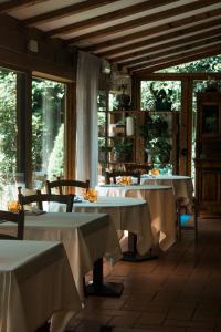 a dining room with two tables with white table cloth at Rama Relais in Caprino Veronese