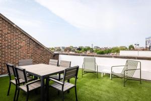 a patio with a table and chairs on a roof at Monarch House - Serviced Apartments - Kensington in London