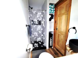 a room with a door and a wall with a wallpaper at Sea & Sun Cottage #1 in Hampton