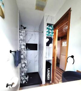 a bathroom with a shower in a room at Sea & Sun Cottage #1 in Hampton +19 photos