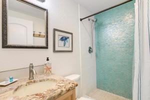 a bathroom with a sink and a shower at Beach Dreams Resort in Bradenton Beach