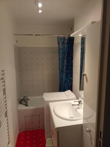 a bathroom with a sink and a tub and a shower at Appartement 5 personnes centre de Luchon in Luchon