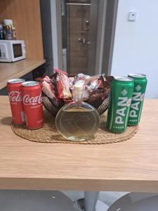 a tray with cocacola soda and snacks on a table at Apartman Pariz in Slavonski Brod