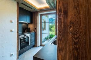 a kitchen with a sink and a large window at Appartements Hochödlehen in Schönau am Königssee
