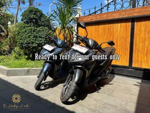 a motorcycle parked on a sidewalk next to a fence at The Heritage Kraton Guest House in Timuran