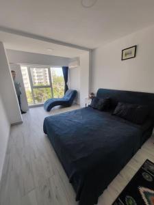 a bedroom with a large blue bed and a chair at Aquamarine Olimp in Olimp +27 photos